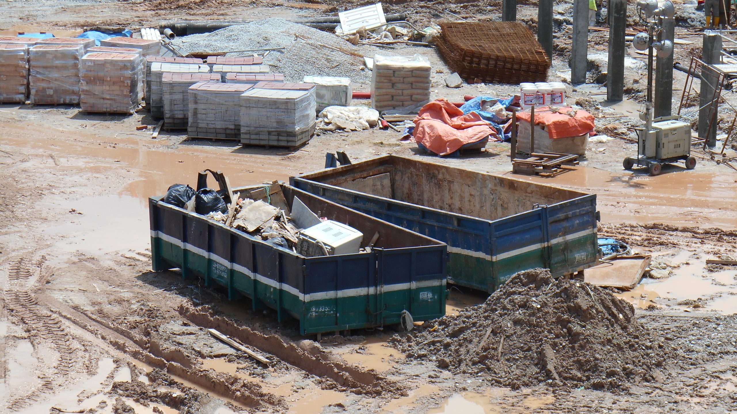 A pair of roll-off dumpsters on a construction site