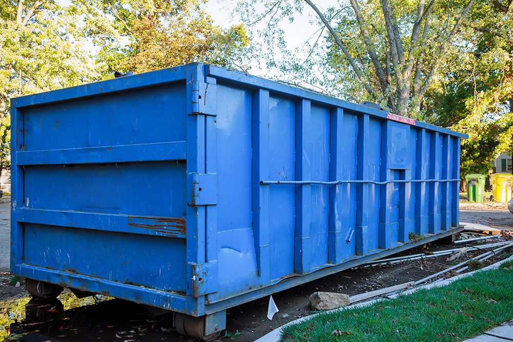 A large blue dumpster.